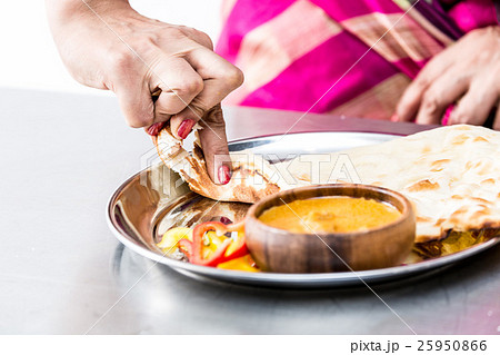 カレーを食べるインド人の手の写真素材