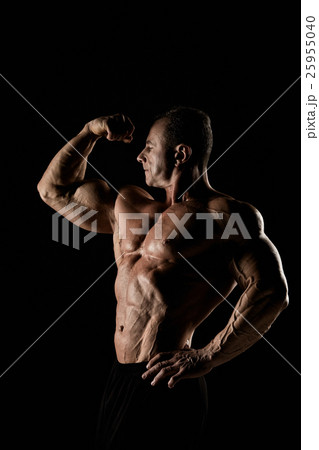 torso of attractive male body builder on black 25955040
