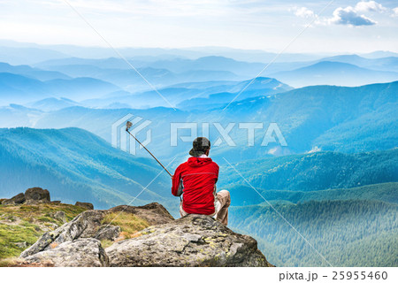 Young man on mountain taking selfie Young man on mountain taking selfie 25955460