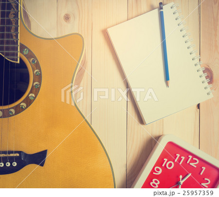 Time for Guitar song writing with a red clock. 25957359