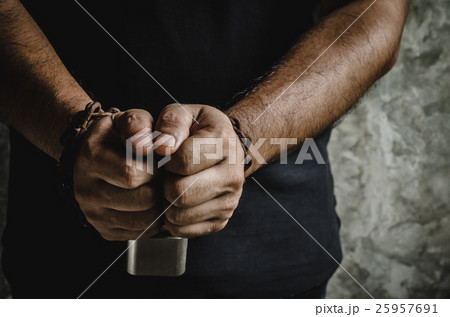A man of two hands chained with old rusty chain A man of two hands chained with old rusty chain 25957691