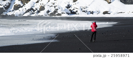 Photographer at black sand beach in Vik, Iceland Photographer at black sand beach in Vik, Iceland 25958971