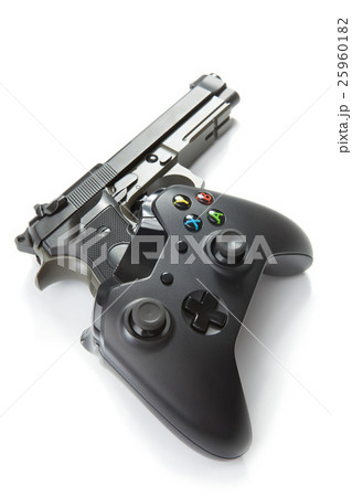 Video game controller with real handgun near it 25960182