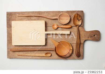 Various kitchen utensil on white wooden background 25962253