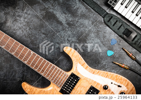 Electric guitar on grey background Electric guitar on grey background 25964133