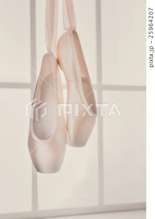 Pink ballet pointe shoes hanging on window Pink ballet pointe shoes hanging on window 25964207
