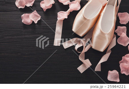 Pink ballet pointe shoes on black wood background Pink ballet pointe shoes on black wood background 25964221