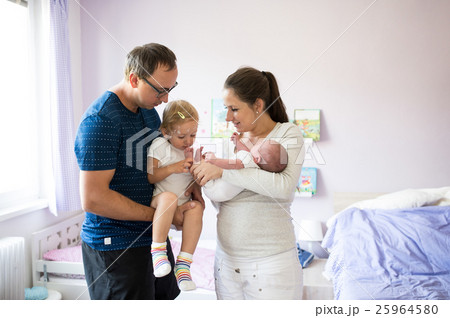 Father holding daughter with chickenpox. Mother 25964580