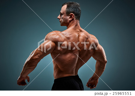 torso of attractive male body builder on gray 25965551