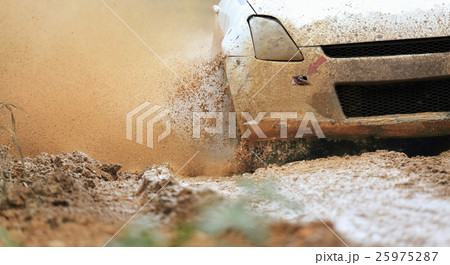 Rally car in muddy road 25975287
