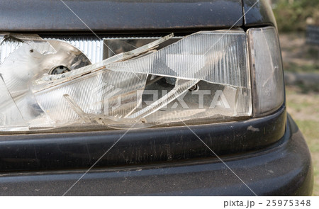 damaged car headlamp after collision 25975348