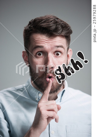 Man is looking wary. Over gray background 25979288