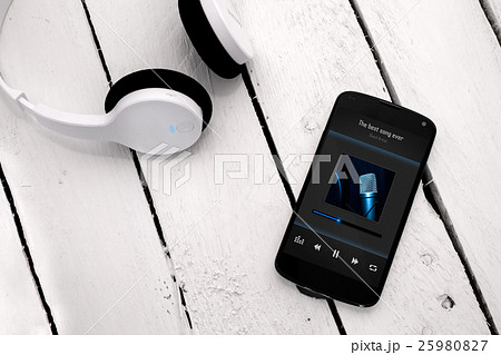 Modern smartphone with bluetooth headphones. 25980827