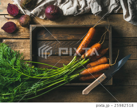 Fresh carrots and beetroots in wooden tray over 25982518