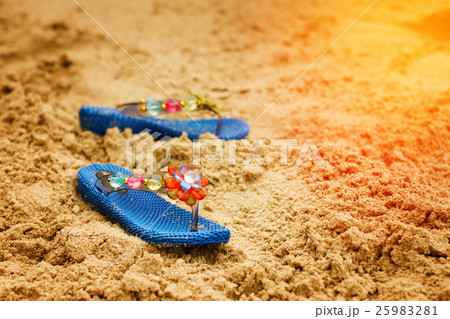 Beach flip flops on tropical sandy coast Beach flip flops on tropical sandy coast 25983281