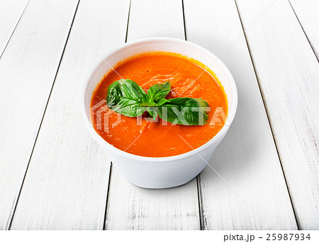 Hot food delivery - tomato gazpacho soup isolated Hot food delivery - tomato gazpacho soup isolated 25987934