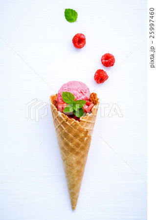 Raspberry ice cream in cone with fresh raspberry . Raspberry ice cream in cone with fresh raspberry . 25997460
