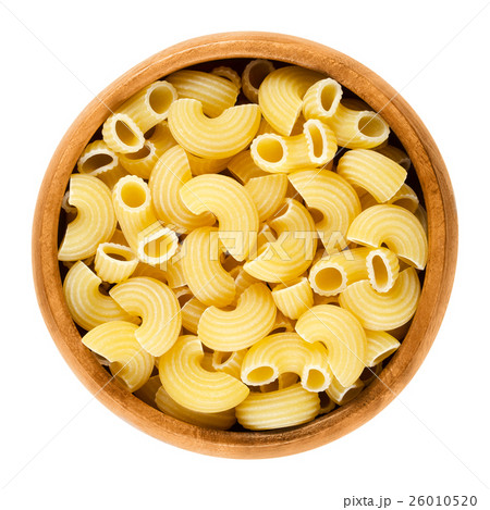 Chifferi pasta in wooden bowl over white 26010520