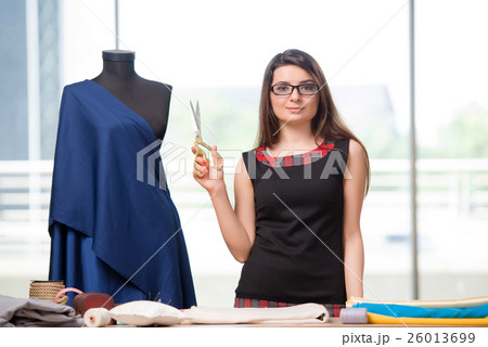 Woman tailor working on new clothing Woman tailor working on new clothing 26013699