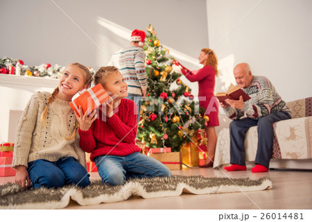 Happy kids having fun with holiday presents Happy kids having fun with holiday presents 26014481