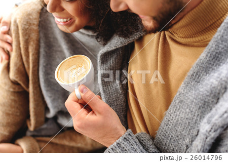 cheerful couple enjoying a hot latte 26014796