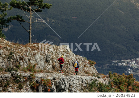 two male runners on top mountain two male runners on top mountain 26024923