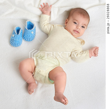 baby portrait lie on white towel in bed 26028868