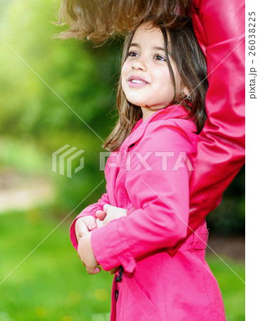 pretty little girl in the arms of her mother 26038225