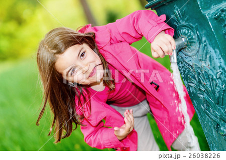 cute kid about to drink water in a fountain 26038226