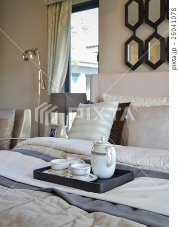 decorative tea cup set on black tray in bedroom 26041078
