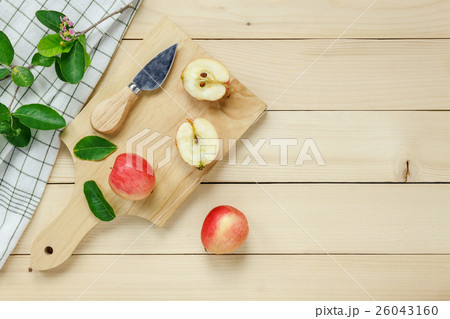 red apple sliced,knife,napkin, leaf on wooden. red apple sliced,knife,napkin, leaf on wooden. 26043160