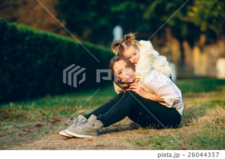 Mother and little daughter in a park Mother and little daughter in a park 26044357