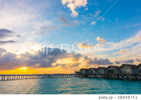 Beautiful sunrise with water villas in tropical Maldives island . 26049751