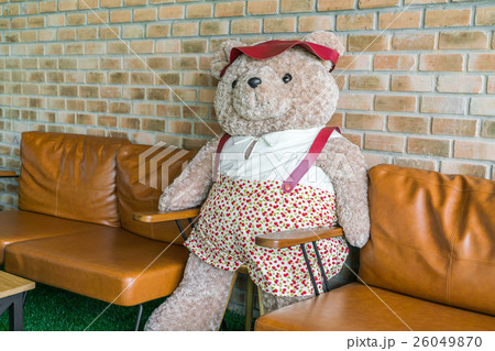 Cute teddy bear sitting on chair . 26049870