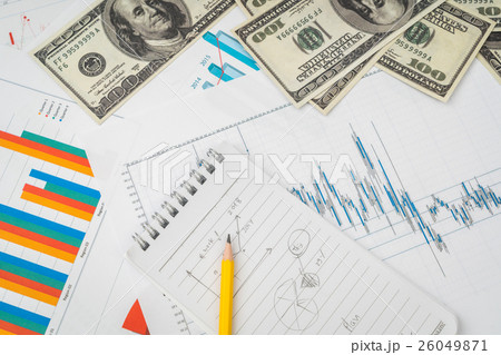 Financial charts on the table with dollars banknotes . 26049871