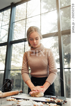 Young woman knead dough at kitchen, bakery making 26050759