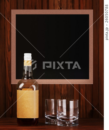 Glasses with ice for whiskey and bottle on wooden background. Glasses with ice for whiskey and bottle on wooden background. 26050788