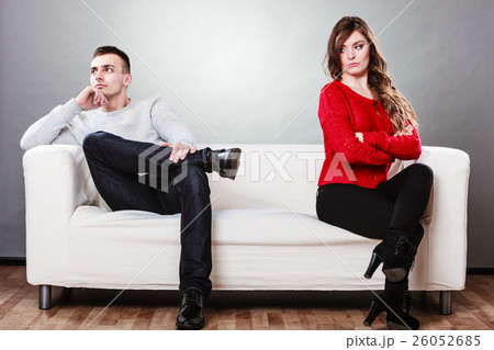Young couple after quarrel sitting on sofa Young couple after quarrel sitting on sofa 26052685