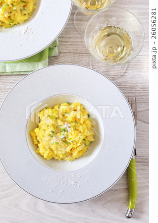 Risotto with saffron and glass of white wine 26056281
