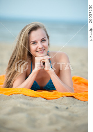 Young lady sunbathing on a beach. Beautiful woman 26057250