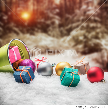 Christmas balls and gifts on snow Christmas balls and gifts on snow 26057897