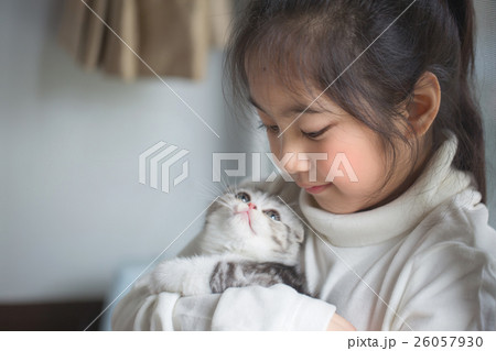 Happy little Asian girl hugging scottish fold cat Happy little Asian girl hugging scottish fold cat 26057930