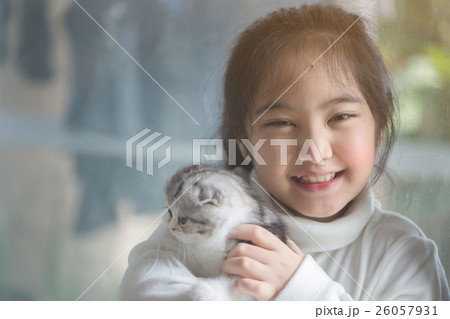Happy little Asian girl hugging scottish fold cat 26057931