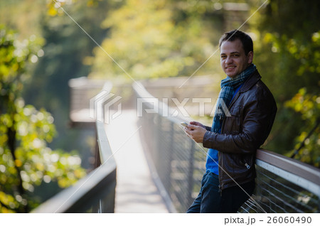 Handsome happy hipster young man using smart phone Handsome happy hipster young man using smart phone 26060490