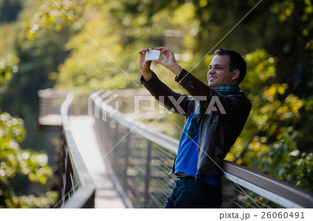 male traveler with smart phone taking a photo of male traveler with smart phone taking a photo of 26060491