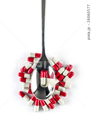 Capsules over silver spoon, Healthcare Medicine 26060577