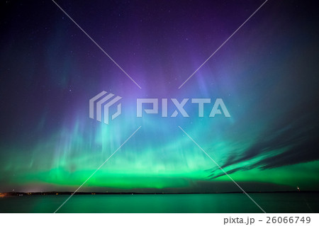 Northern lights over lake in finland 26066749