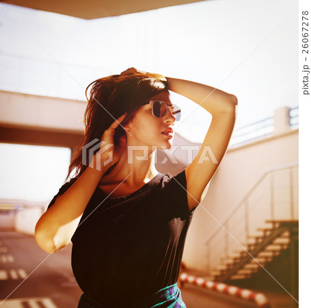 Urban fashionable girl posing outdoors in the city 26067278