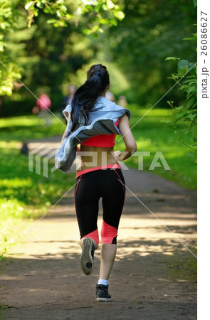 Beautiful woman runner running in city park Beautiful woman runner running in city park 26086627