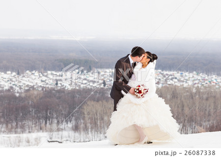 Romantic kiss happy bride and groom on winter Romantic kiss happy bride and groom on winter 26087338